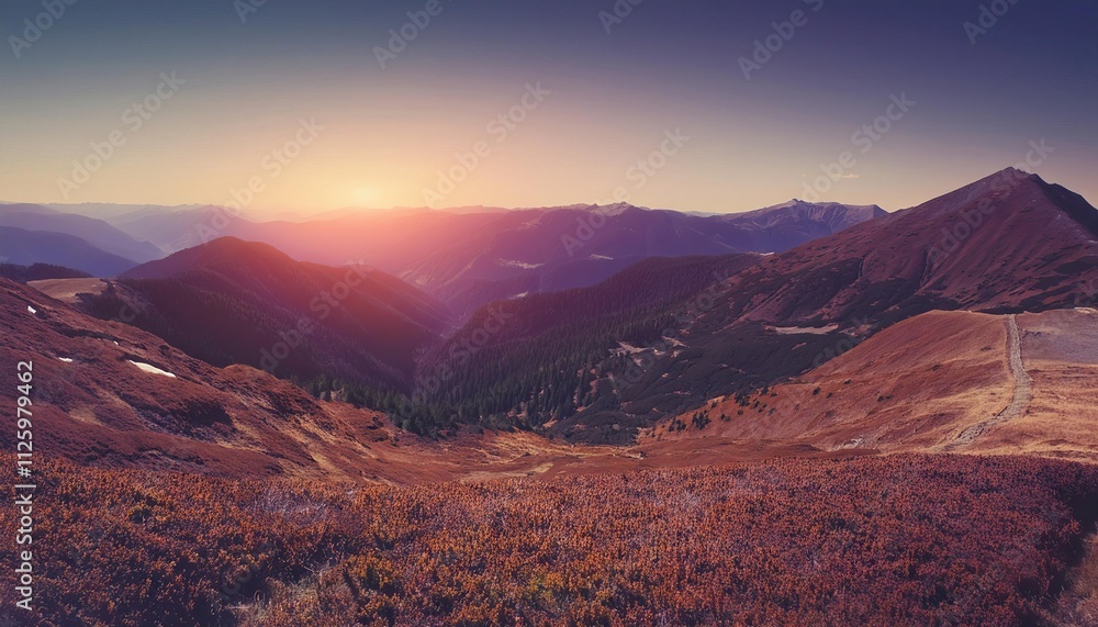 A panoramic view of mountains at sunrise and sunset with snowy peaks and a vibrant sky A panoramic view of mountains at sunrise and sunset with snowy peaks and a vibrant sky