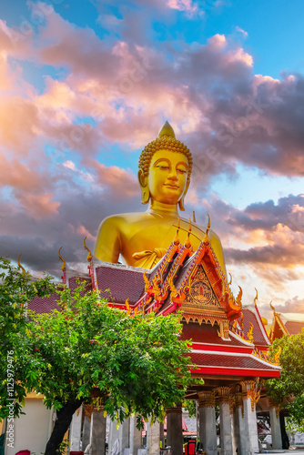 Big Buddha Dhammakaya Tep Mongkol Buddha of Paknam Bhasicharoen temple roof in Thonburi sunset clouds background. photo