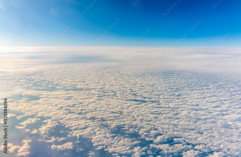 View from the airplane window at a beautiful cloudy sky and the airplane wing View from the airplane window at a beautiful cloudy sky and the airplane wing