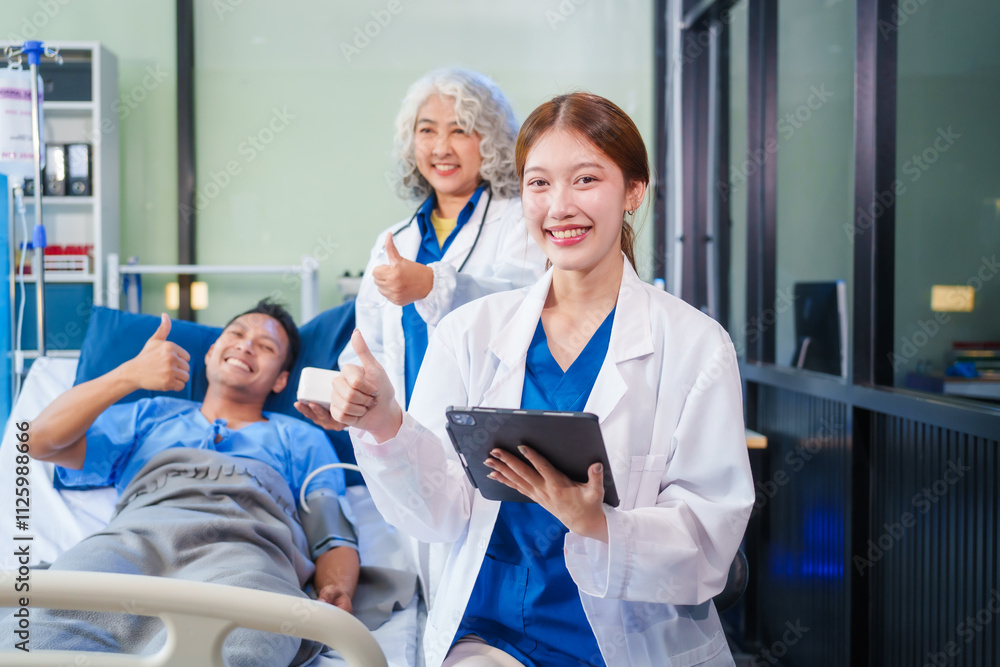 Fototapeta premium Two female doctors examine a patient lying on a hospital bed,discuss the medical chart,administer medicine,and provide encouragement, ensuring compassionate care and fostering the patient's recovery