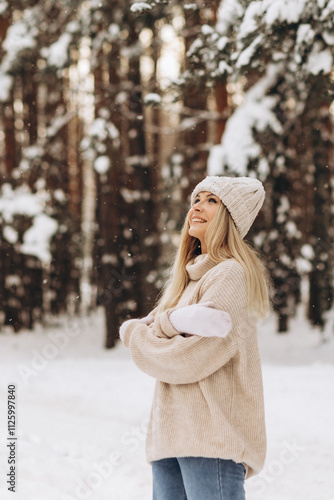 Portrait beautiful young woman in a sweater, knitted hat, mittens. Concept of magical winter time, holidays