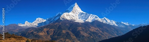 Majestic snow capped Himalayan mountain peak under a clear blue sky