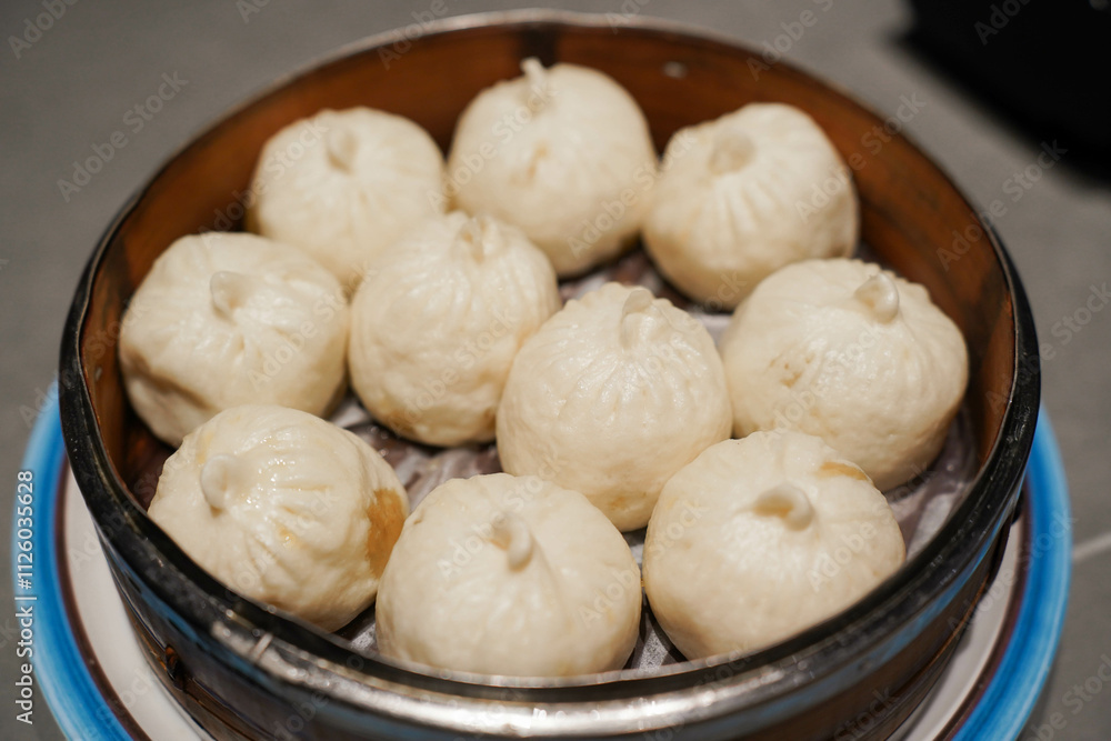 Steamed xiao long bao in bamboo steaming bowl. Chinese steamed bun. Dim sum. Chinese food