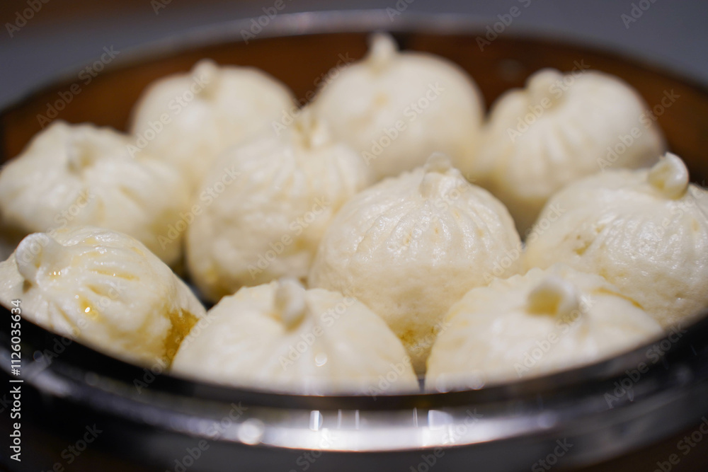 Steamed xiao long bao in bamboo steaming bowl. Chinese steamed bun. Dim sum. Chinese food