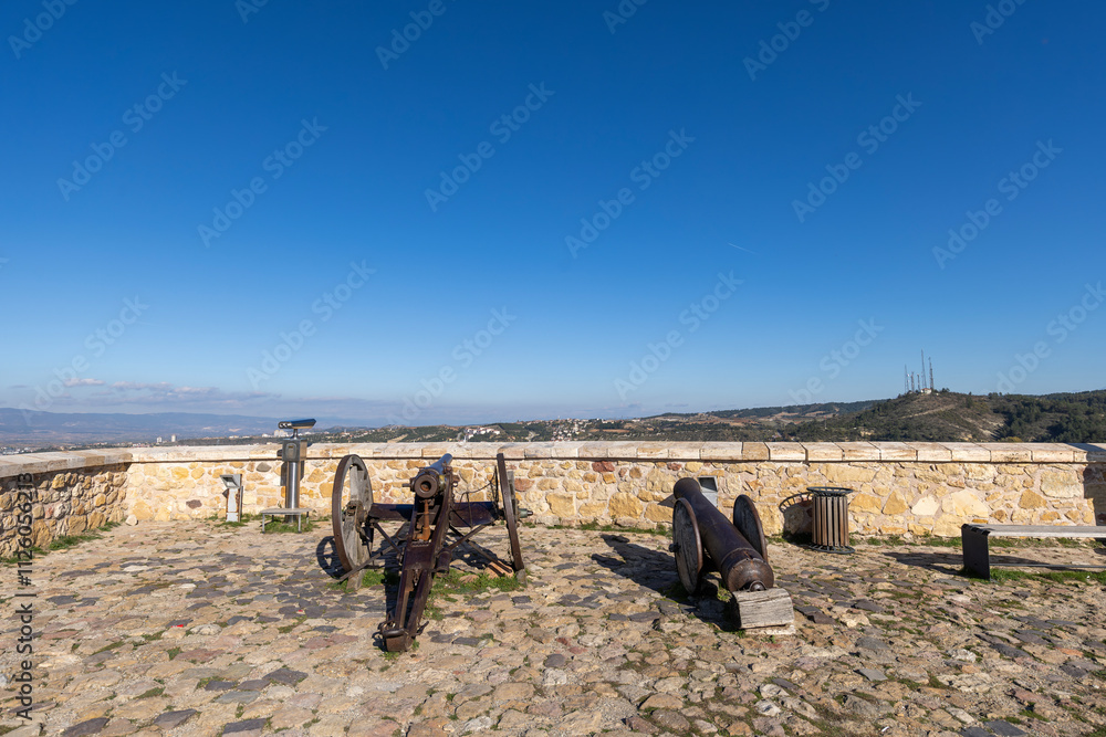 Two historical cannon on old stone floor and stone walls in old historical castle