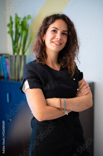 Physiotherapist smiling with crossed arms in her clinic
