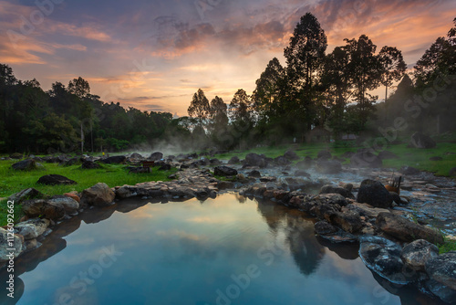 Hot springs over rock terrain with misty and morning sunrise rays and Natural Mineral Water of Chae Son National Park in Lampang Province, Thailand.