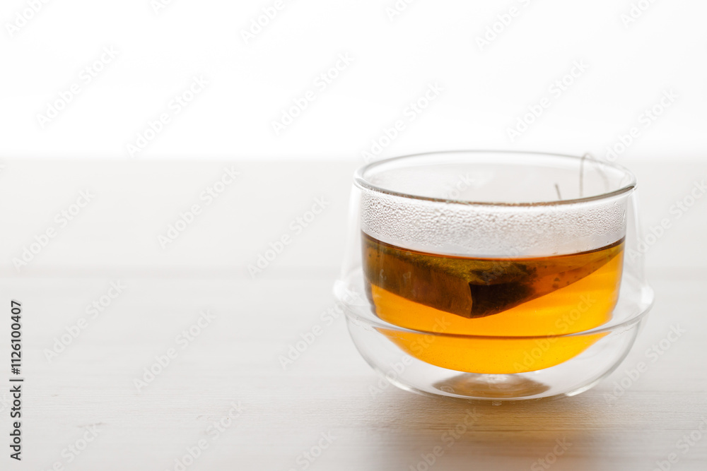 Cup of hot tea blended from rooibos, spearmint, apple, baobab on white wooden table. Cup of hot tea blended from rooibos, spearmint, apple, baobab on white wooden table.