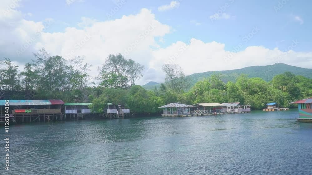 Serene Lakeside Retreat: Colorful Floating Cabins Nestled in Lush Green Hills Serene Lakeside Retreat: Colorful Floating Cabins Nestled in Lush Green Hills