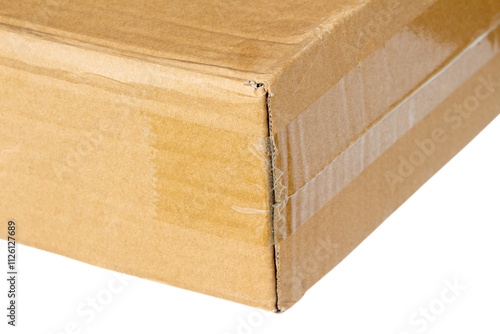 Close-up view of the corner of a cardboard box sealed with transparent tape