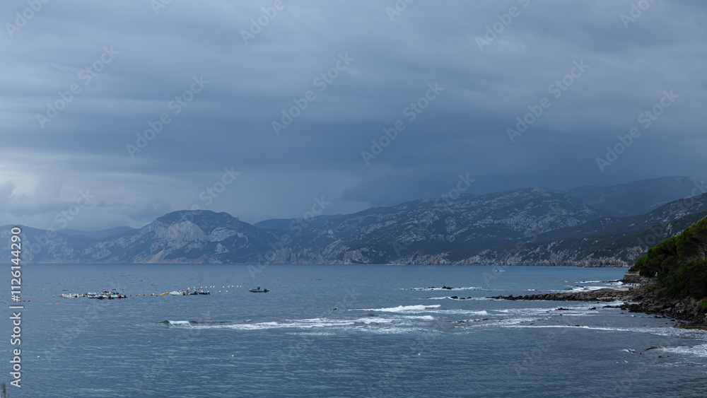 Turquoise wave and dramatic clouds on the coast, Mediterranean Sea, Sardinia Turquoise wave and dramatic clouds on the coast, Mediterranean Sea, Sardinia