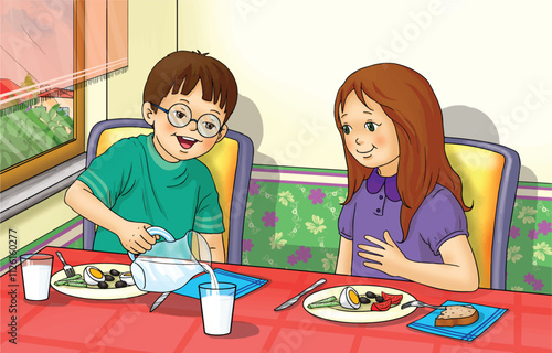 Children having breakfast together. A child pouring milk into his friend's glass.