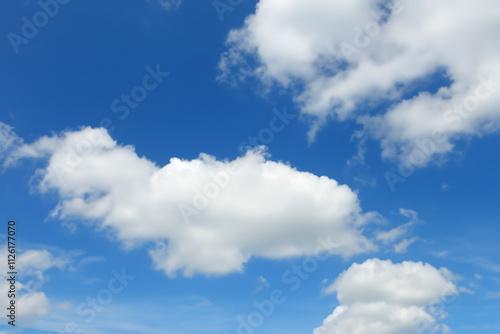 Blue sky with white clouds. The background is a clear blue sky without any clouds. A wide-angle view of the entire picture, showing vast and endless skies. photo