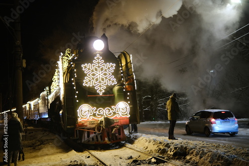 Christmas train with steam locomotive and illumination