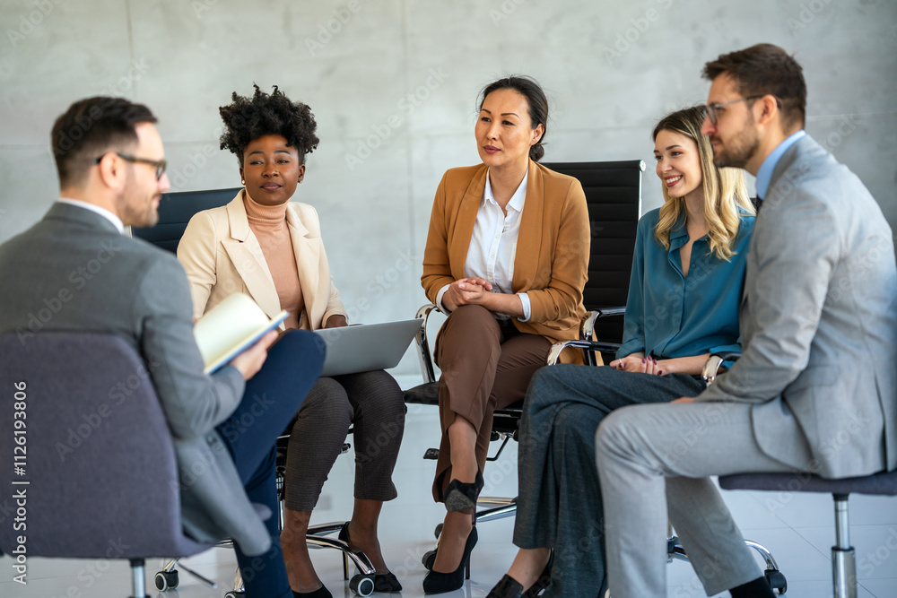 People in group therapy having an interesting discussion. Business team listening to coach People in group therapy having an interesting discussion. Business team listening to coach