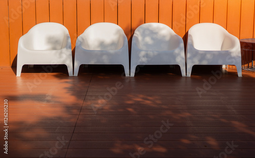 Modern design white plastic chairs at swimming pool side and outdoor garden photo