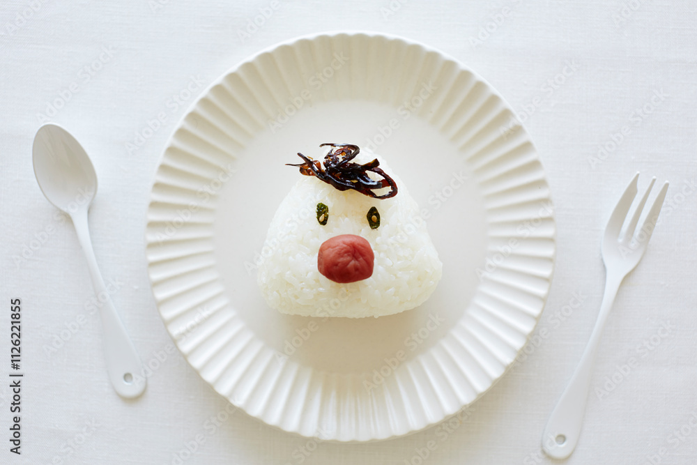Rice ball with face on a plate Rice ball with face on a plate