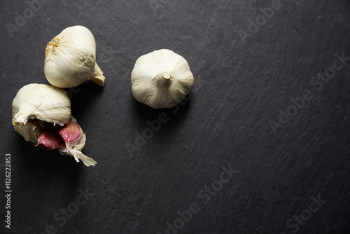 Purple garlic on a black stone baking tray