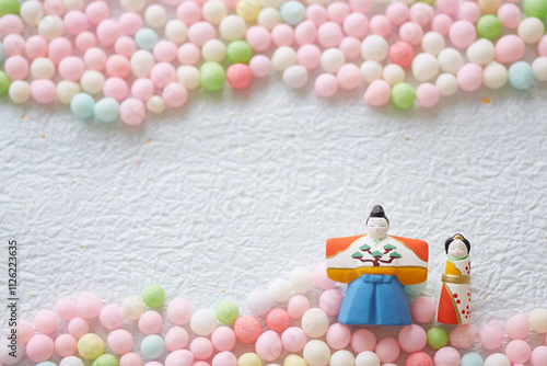 Hina dolls, hina arare and peach blossoms on washi paper photo