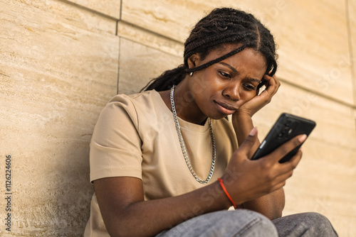 Young African American frustrated and upset outdoors urban building photo