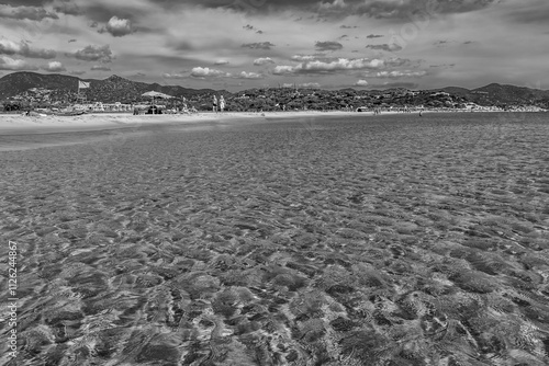 Fototapeta Naklejka Na Ścianę i Meble -  Black and white view of a beautiful sandy beach in summer season, Porto Giunco, Sardinia, Italy
