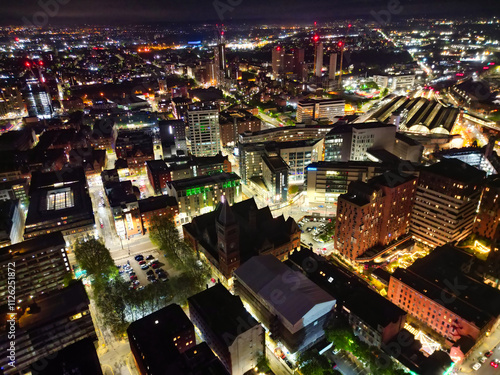 Aerial Night View of Illuminated Central Manchester City and Downtown Buildings, England United Kingdom. High Angle Footage Was Captured with Drone's Camera on May 4th, 2024 During Midnight. photo