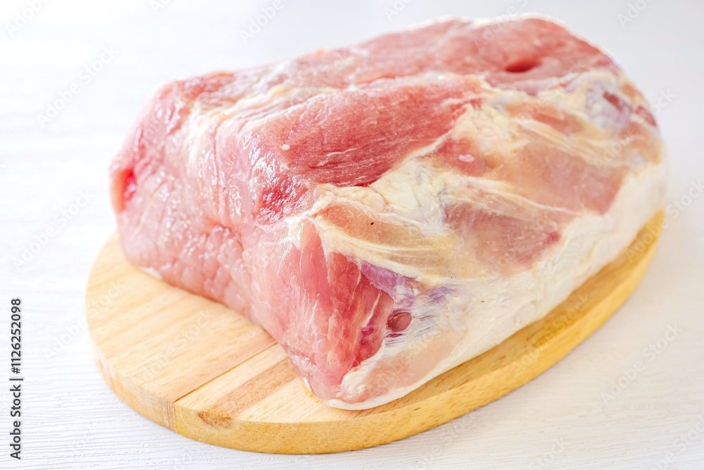 Pieces of Pork in cutting board on a white background, Pieces of Pork in cutting board on a white background,
