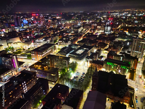 Aerial Night View of Illuminated Central Manchester City and Downtown Buildings, England United Kingdom. High Angle Footage Was Captured with Drone's Camera on May 4th, 2024 During Midnight. photo