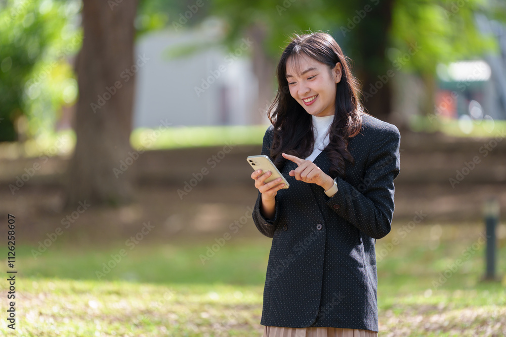 Young Asian business woman works remotely in her luxurious office holding a modern laptop talking on the phone. Contact customers on social media, online, fashion concept, technology. Young Asian business woman works remotely in her luxurious office holding a modern laptop talking on the phone. Contact customers on social media, online, fashion concept, technology.