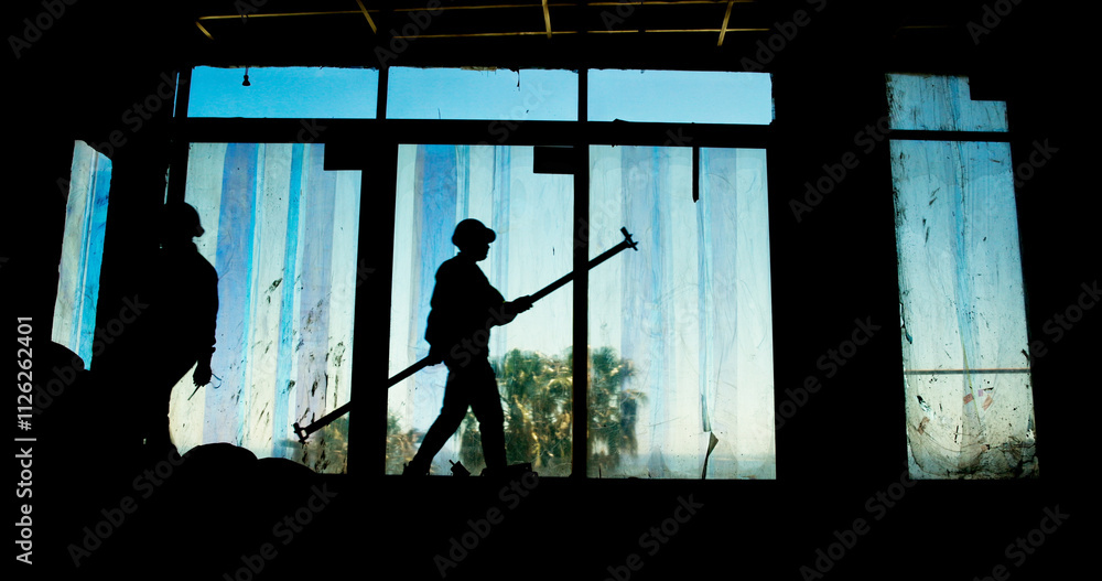 People, tools and silhouette on construction site for urban development, engineering or renovation. Industry team, shadow or project working with communication, process or property development People, tools and silhouette on construction site for urban development, engineering or renovation. Industry team, shadow or project working with communication, process or property development