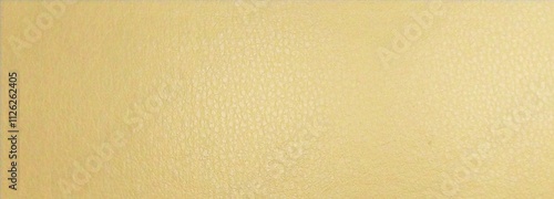 a close-up of a textured surface with a light yellow or beige color. The texture appears to be slightly grainy or pebbled, similar to a fine leather or a textured wall photo