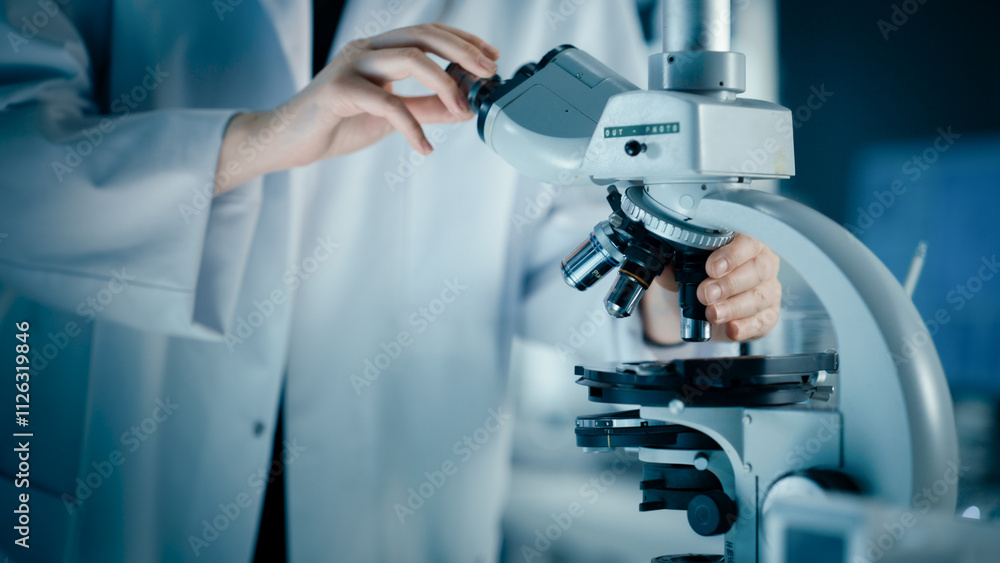 Close Up of a Scientist Using Microscope to Analyze Biological Specimens. Anonymous Person Adding Liquid Solution to Multiple Petri Dishes. Laboratory Work for Advancing Medical Knowledge Close Up of a Scientist Using Microscope to Analyze Biological Specimens. Anonymous Person Adding Liquid Solution to Multiple Petri Dishes. Laboratory Work for Advancing Medical Knowledge