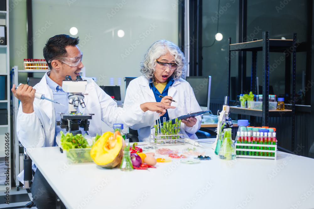 A female and male scientist conduct plant research in a laboratory, using microscopes, petri dishes,test tubes. researchers analyze genetically modified plants, vegetables, pork, nutritional value A female and male scientist conduct plant research in a laboratory, using microscopes, petri dishes,test tubes. researchers analyze genetically modified plants, vegetables, pork, nutritional value