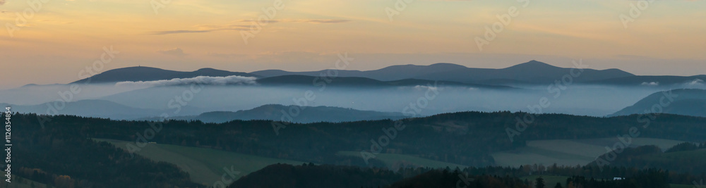 Fototapeta premium Colorful sunset over the Czech countryside. View from the Teplice-Adršpašské rocks of the Giant Mountains and the surrounding hills.