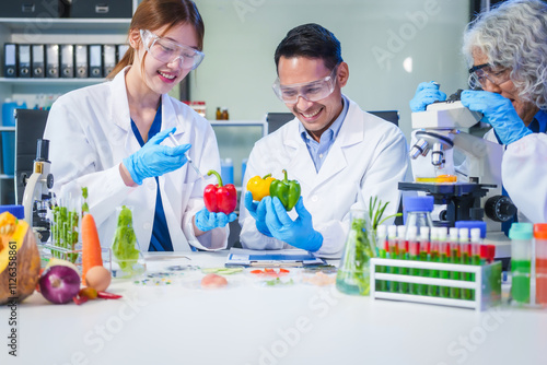 A male scientist and two women conduct plant research in a laboratory.  microscopes, petri dishes,test tubes to analyze genetically modified plants, food, meat, eggs,vegetables for nutritional value