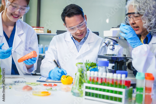 A male scientist and two women conduct plant research in a laboratory. microscopes, petri dishes,test tubes to analyze genetically modified plants, food, meat, eggs,vegetables for nutritional value