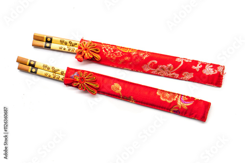 wooden chopsticks and red cloth case on white background