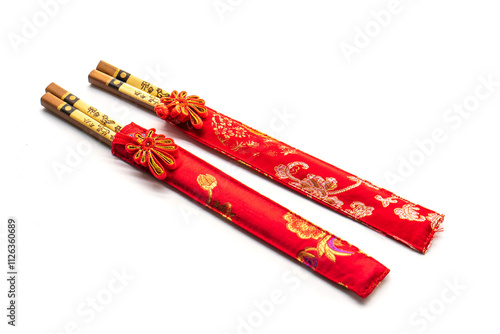 wooden chopsticks and red cloth case on white background