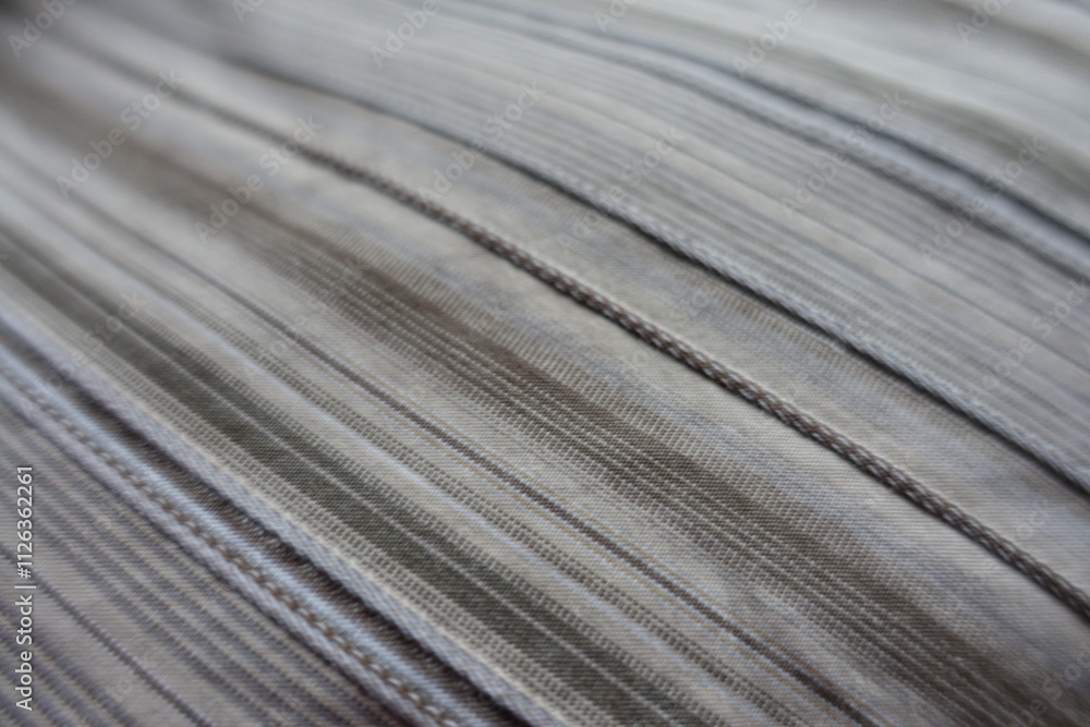 Closeup of beige and grey hairline striped cotton fabric Closeup of beige and grey hairline striped cotton fabric