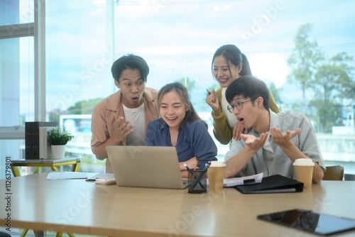 Group of young start up businesspeople celebrating breakthrough or positive results on project in modern office