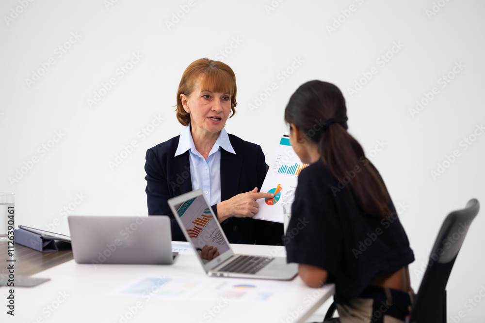 Senior businesswoman. Business discussion. Senior Female insurance agent talking to customers on meeting in the office. Senior businesswoman. Business discussion. Senior Female insurance agent talking to customers on meeting in the office.