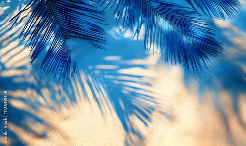 Fototapeta Naklejka Na Ścianę i Meble -  electric blue palm tree shadows creating abstract patterns on the sand