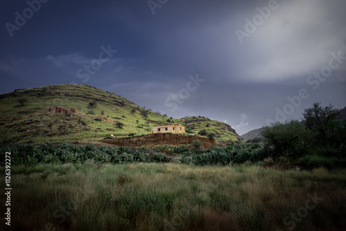 A beautiful landscape photo of cottage on the valley of green hills from As Shafa, Taif  photo