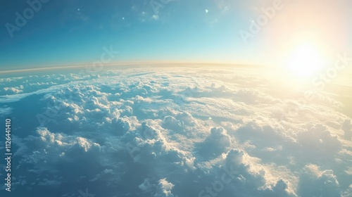 Aerial view of clouds and sunlight over the Earth from an airplane window during flight showcasing serene sky and atmosphere