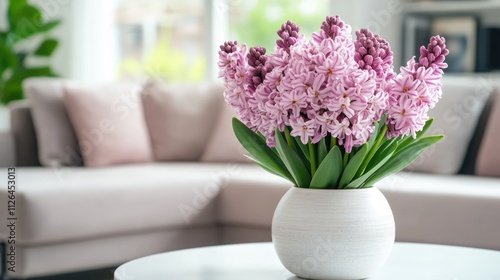 Elegant vase filled with vibrant hyacinth flowers enhancing a modern living room ambiance with soft seating and natural light.