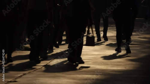 Crowded blurry street . People silhouettes walking in the big street. crowded people walking in the street. shadows of people walking on the street in backlight. city ​​life in sepia tones