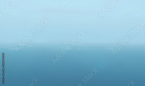 Serene aerial view of a hazy, distant coastline, showcasing a tranquil ocean landscape with subtle color gradients.