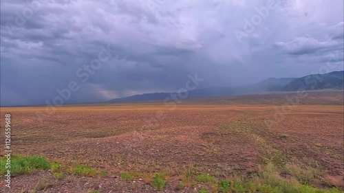 An enchanting and captivating landscape featuring a dramatic stormy sky looming over vast, expansive foothill steppes of Kazakhstan, nature of central asia