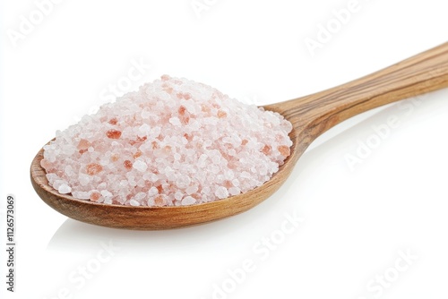 Natural pink salt in a wooden spoon with rustic background showcasing its textured crystals