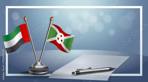 United Arab Emirate and Burundi National flags on small table with bokeh background, cooperative relationship